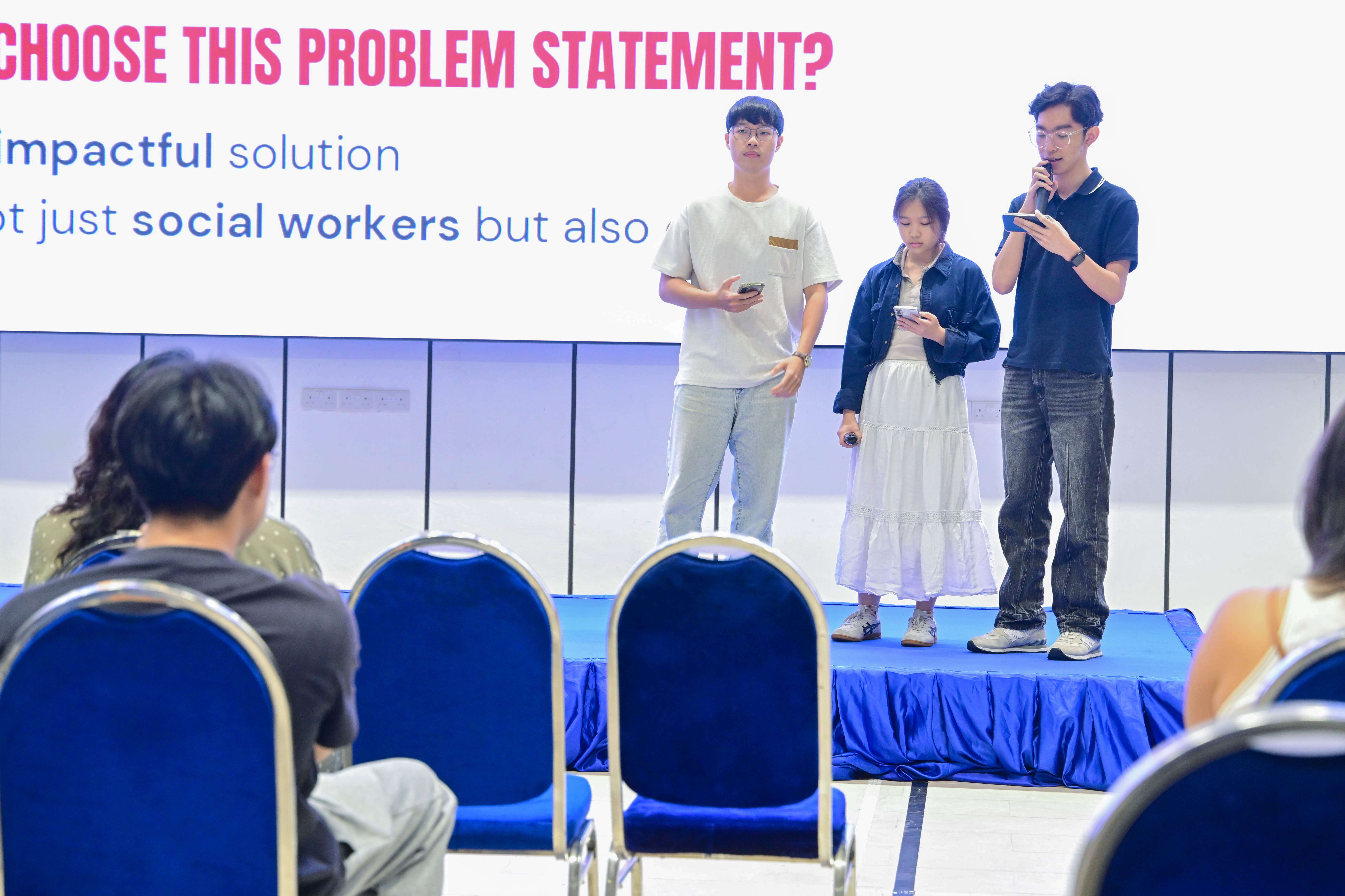 Three students from a group sharing about their problem statement